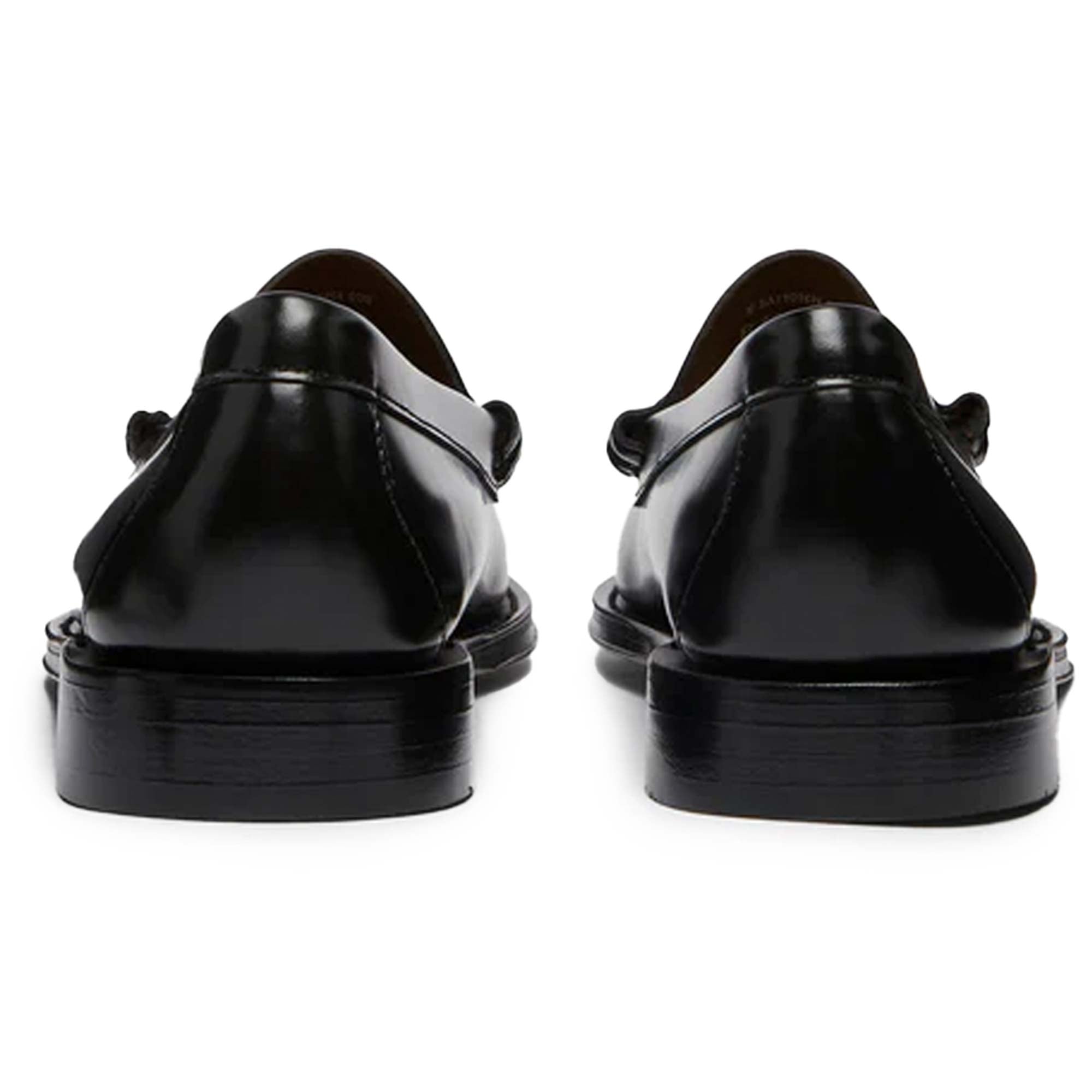 A pair of black leather Penny Loafer shoes, back view.