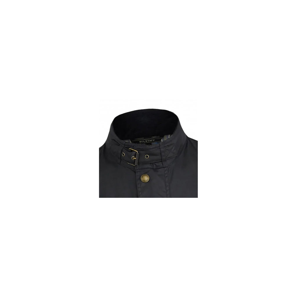 The high collar of a black jacket, with a brass buckle fastening.